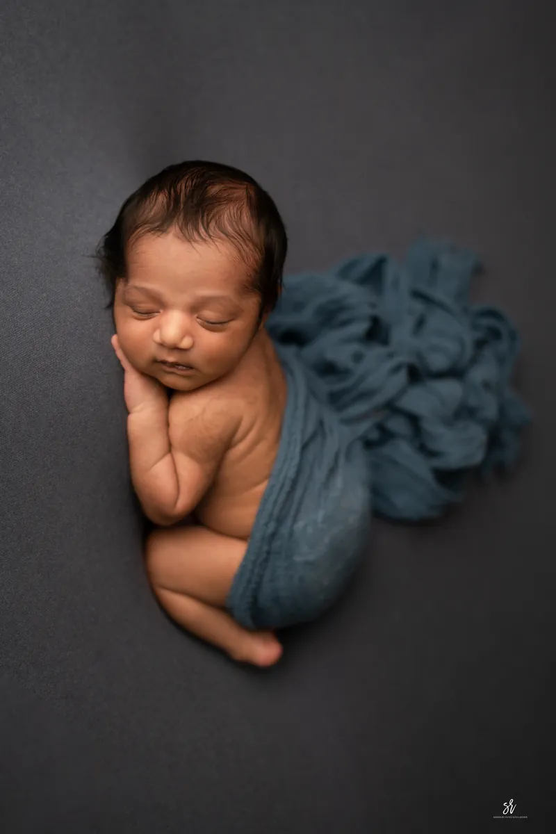 Carefully styled newborn portrait preserving the smallest days · 05