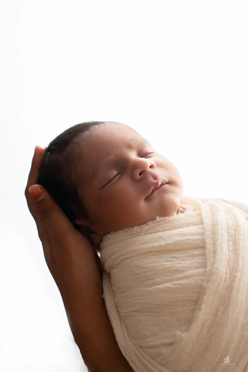 Carefully styled newborn portrait preserving the smallest days · 09