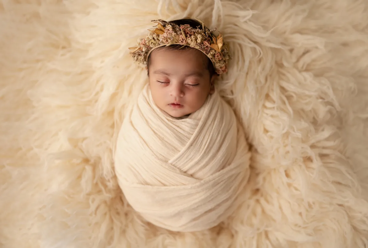 Carefully styled newborn portrait preserving the smallest days · 24