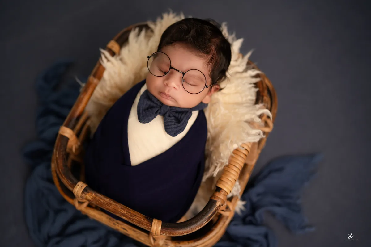 Carefully styled newborn portrait preserving the smallest days · 28